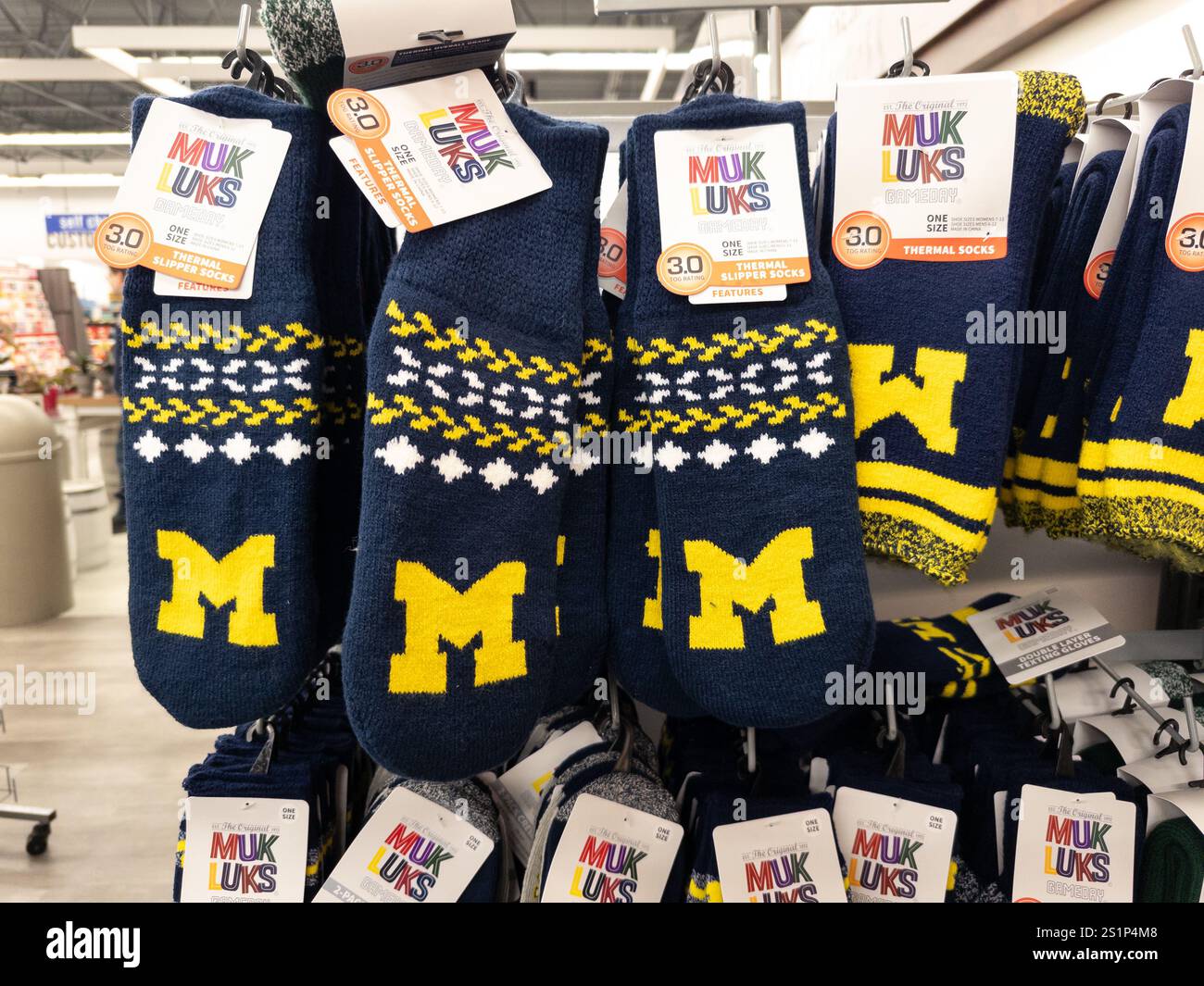 University of Michigan M logo MukLuks thermal slipper socks on display at a Meijer store in Michigan Stock Photo