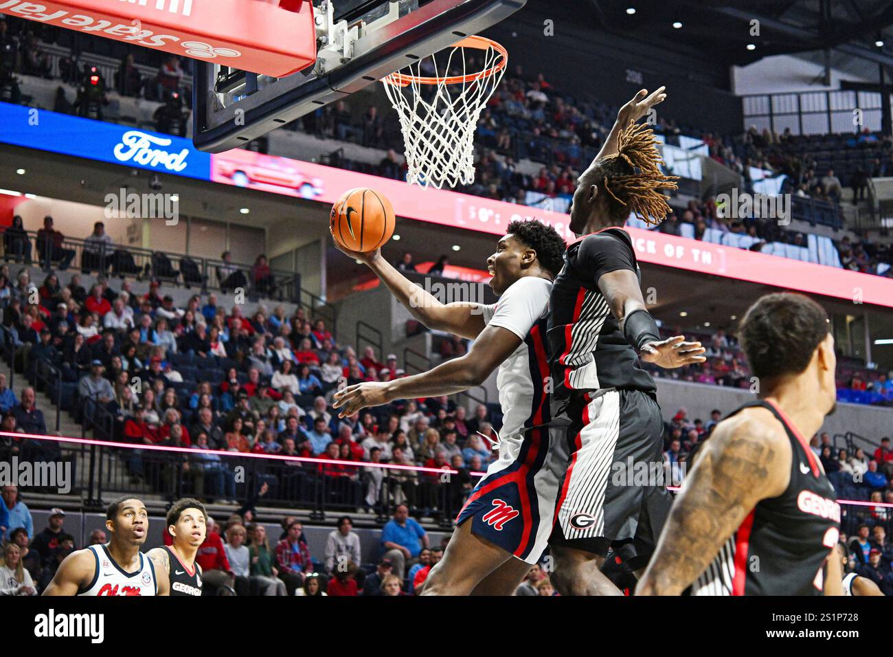 Mississippi forward Malik Dia (0) scores against center Somto