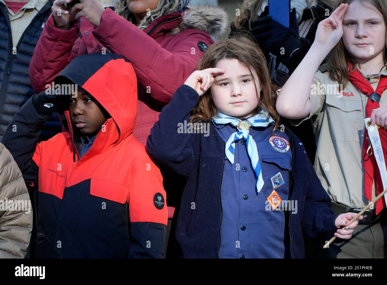 Children watch as the hearse carrying the flagdraped casket of former