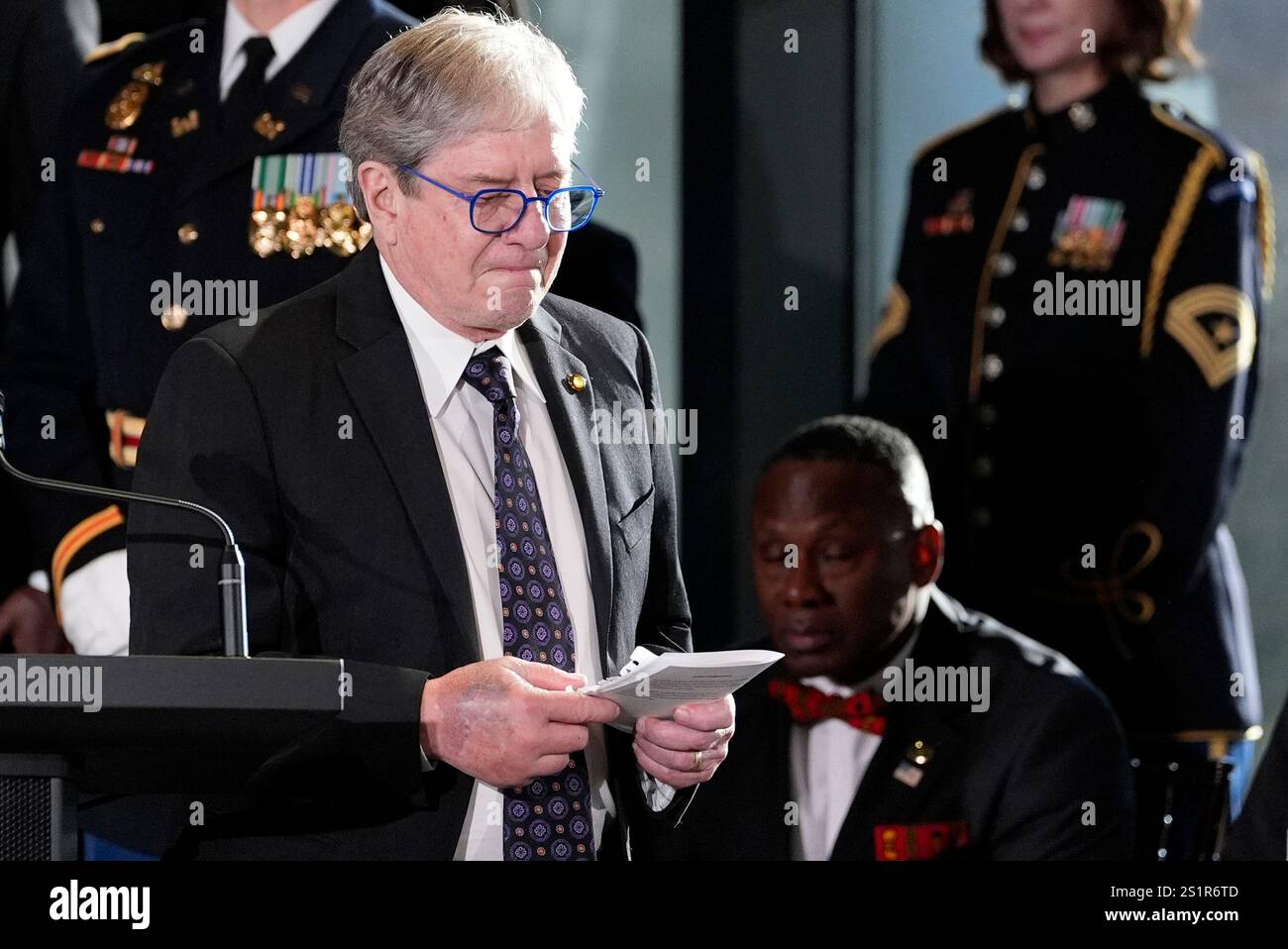 James "Chip" Carter walks after speaking during a service for former