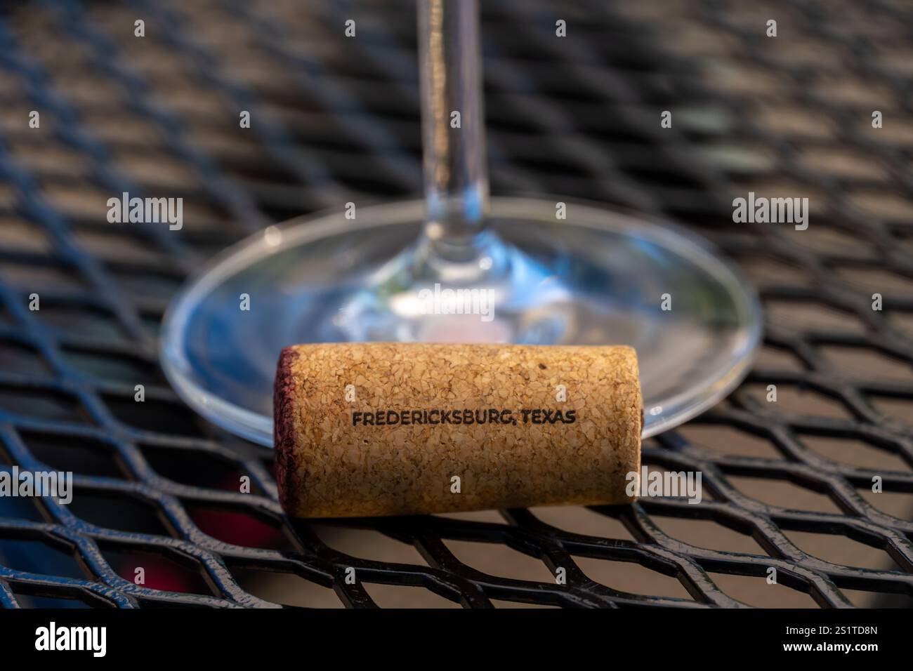 View of Wine Cork with Wine Glass in the background Stock Photo