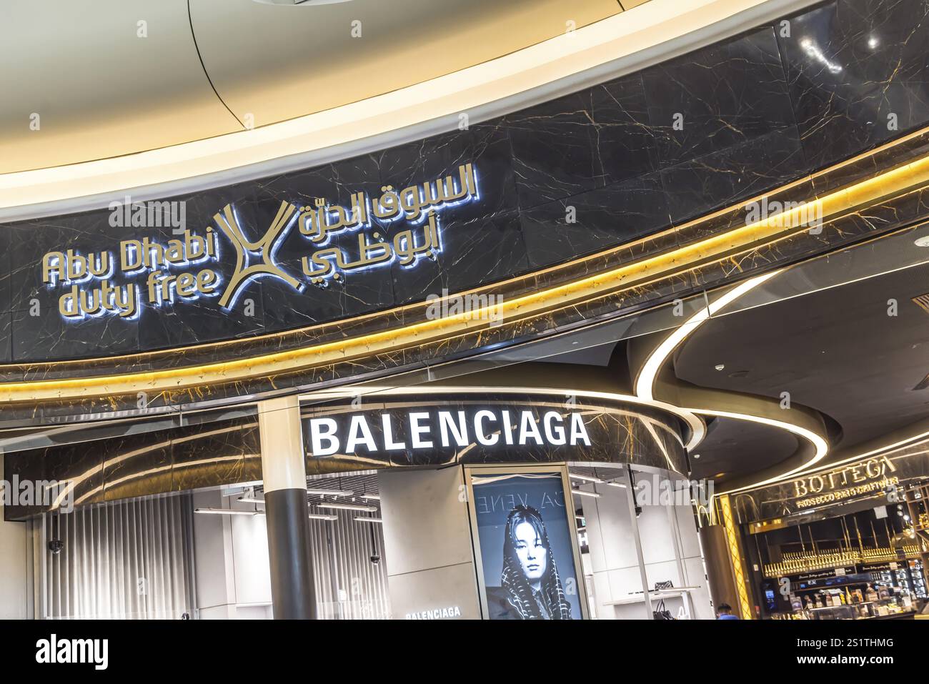 Abu Dhabi Airport, Zayed International Airport with passengers. Duty free shop of the fashion brand Balenciaga. The new Terminal A has a capacity of 4 Stock Photo