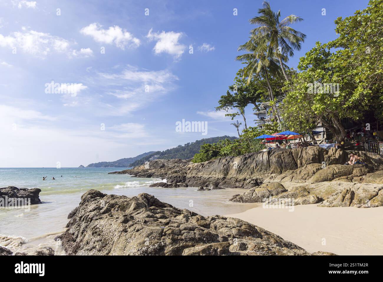 Secluded beach with palm trees and rocks on the coast facing the Indian Ocean. Patong, Kathu, Phuket Island, Thailand, Asia Stock Photo