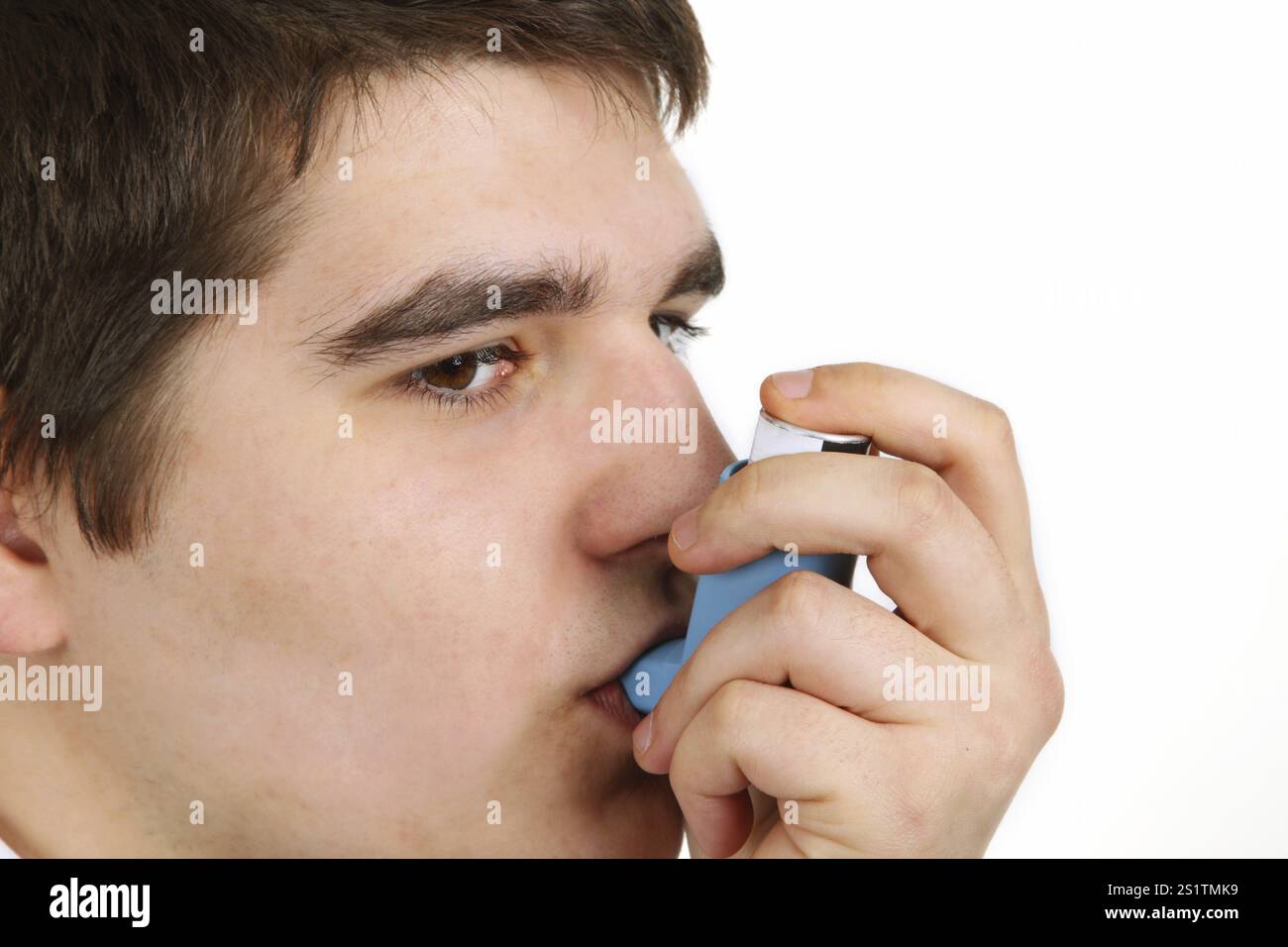Young man with metered dose inhaler on light background Stock Photo - Alamy