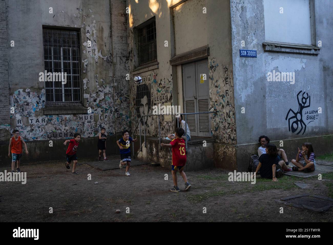 Children play soccer during a protest against the layoffs announced by the government of Javier