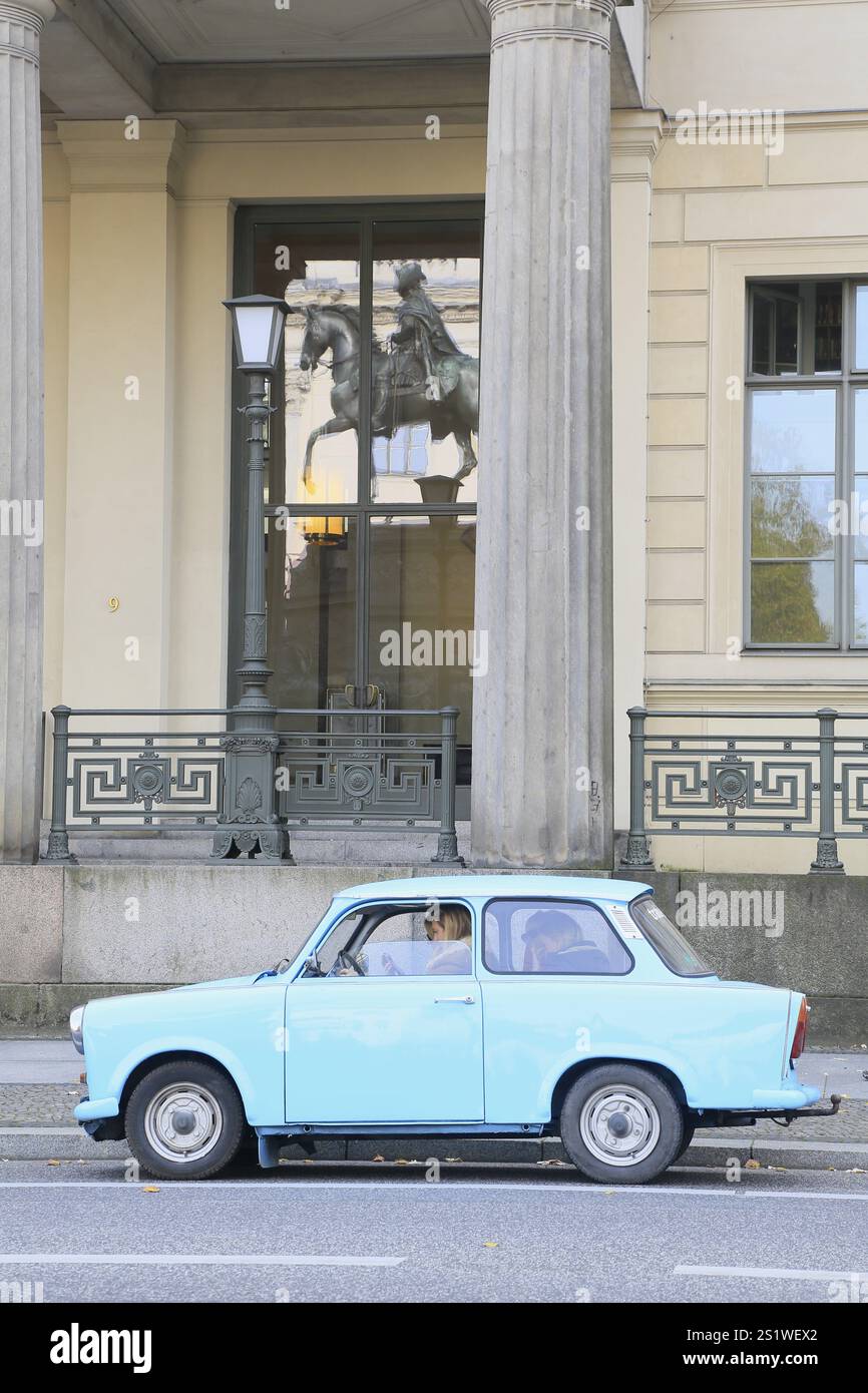 Trabant Trabbi car from VEB Sachsenring Automobilwerke Zwickau on the street Unter den Linden, reflection of the equestrian statue of King Frederick I Stock Photo