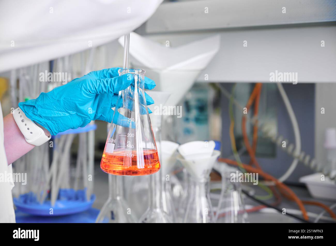 Lab Orange To Collection Scientist holds orange liquid in hi-res stock photography and images ...