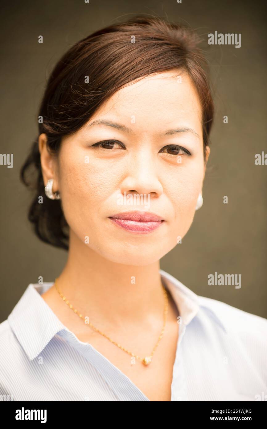 Head and shoulders portrait of Malaysian smiling cheerful adult woman ...