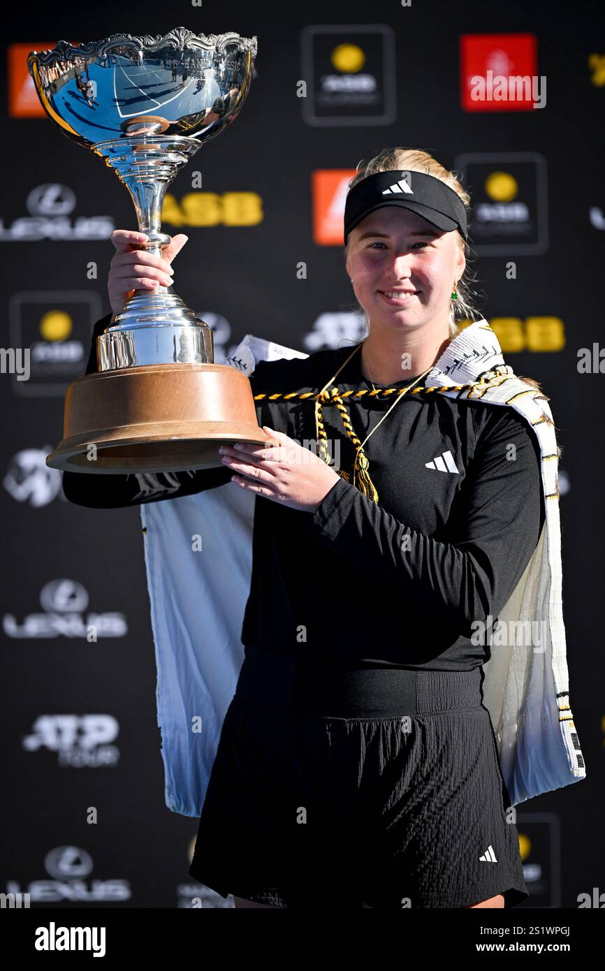 Clara Tauson of Denmark poses with trophy after Naomi Osaka of Japan