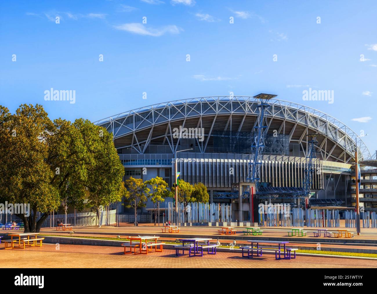 Modern sports arena in Sydney Olympic park multi-purpose stadium under blue sky of Australia. Stock Photo