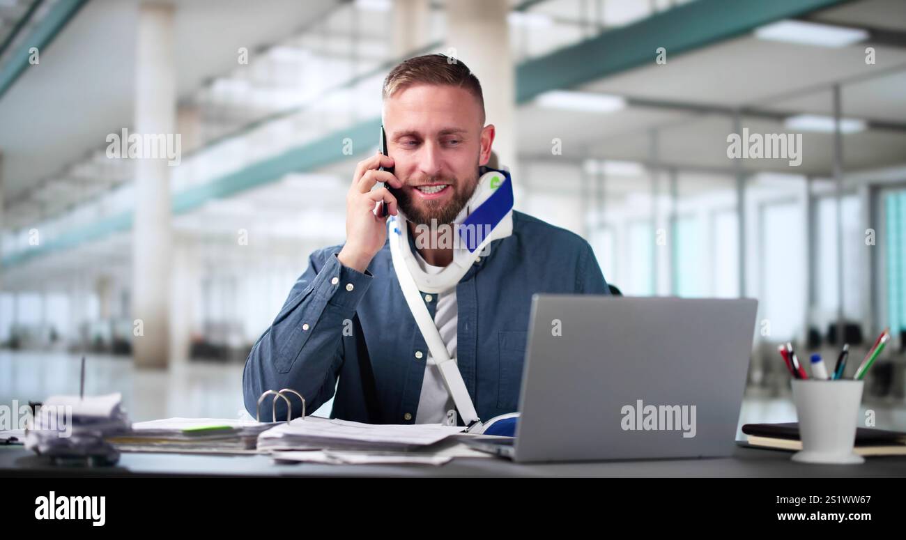 Broken Arm Injured Worker Compensation Coverage. Using Office Laptop Stock Photo