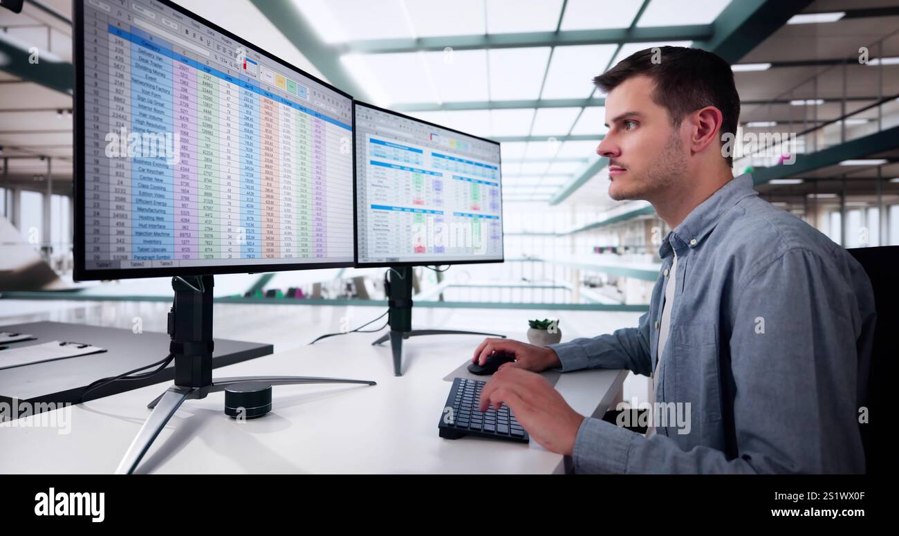 Data Analyst Man Using Spreadsheet On Computer Stock Photo