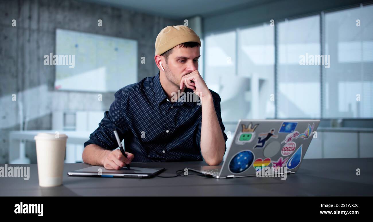 Tired Unhappy Graphics Designer Man Using Laptop Stock Photo