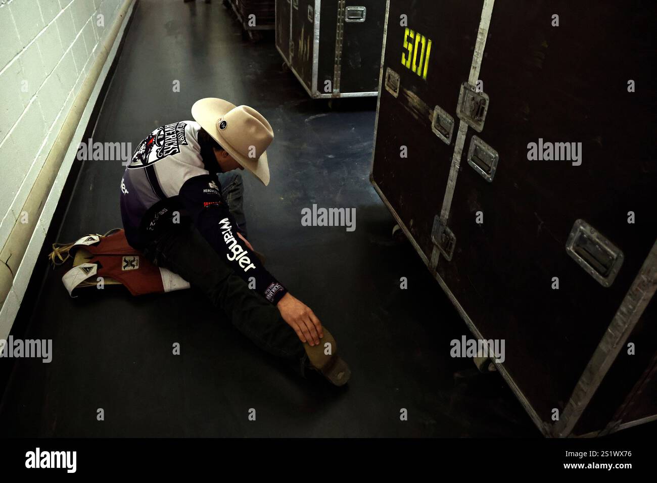 A rider prepares in the locker room during PBR's Unleash The Beast buck