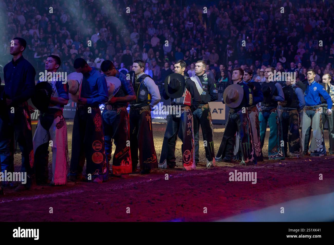 Bull riders stand on the field during the opening ceremony for the ...