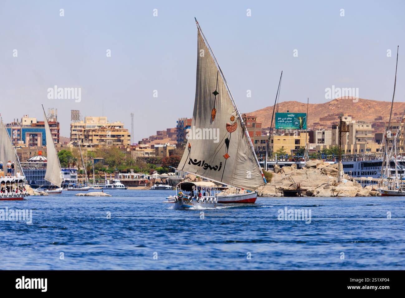 Tourist sailing and motor small ships on the River Nile at Aswan ...