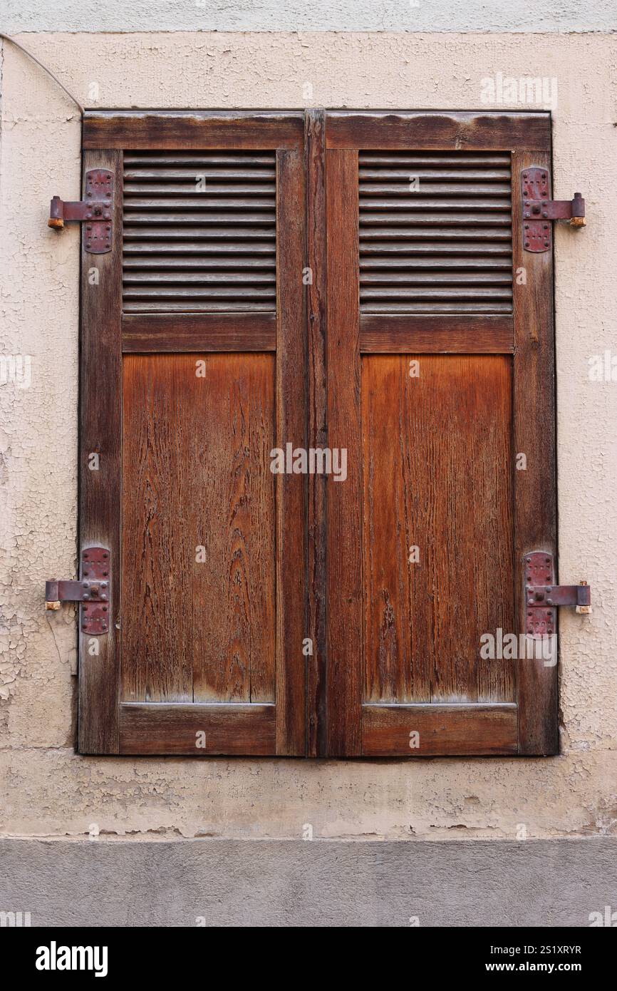 Country style window with closed ancient retro wooden shutters. Antique ...