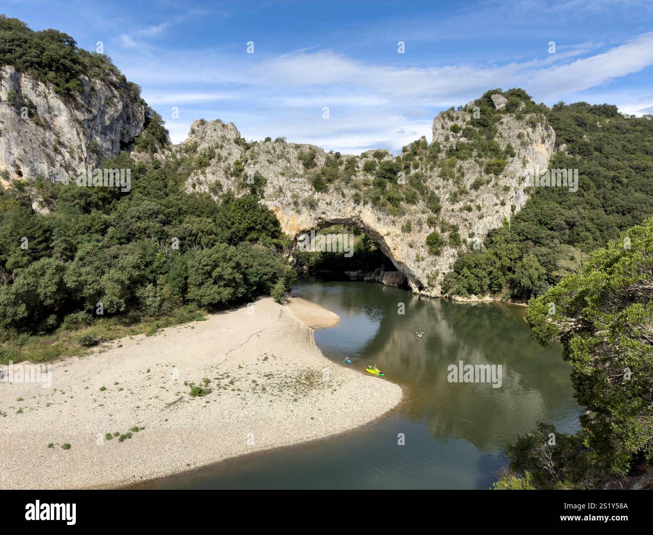 Tourists in canoes and kayaks paddle down the Pont D'Arc arch in the Ardeches Gorges, Rhone Alpes, France - Smartphone Captured Stock Image