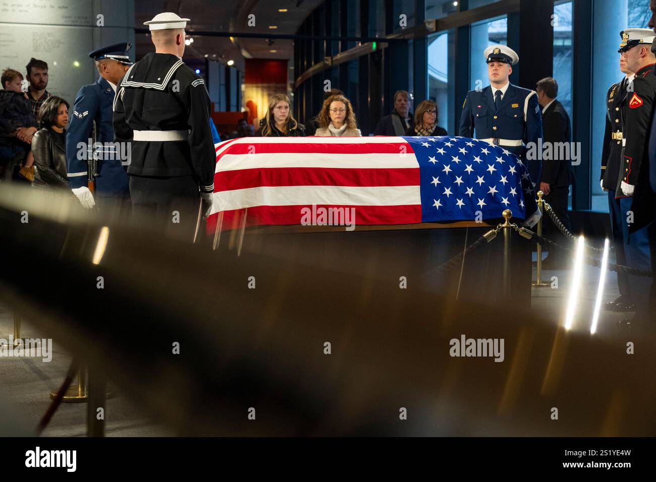 Mourners view the casket of former President Jimmy Carter as he lies in