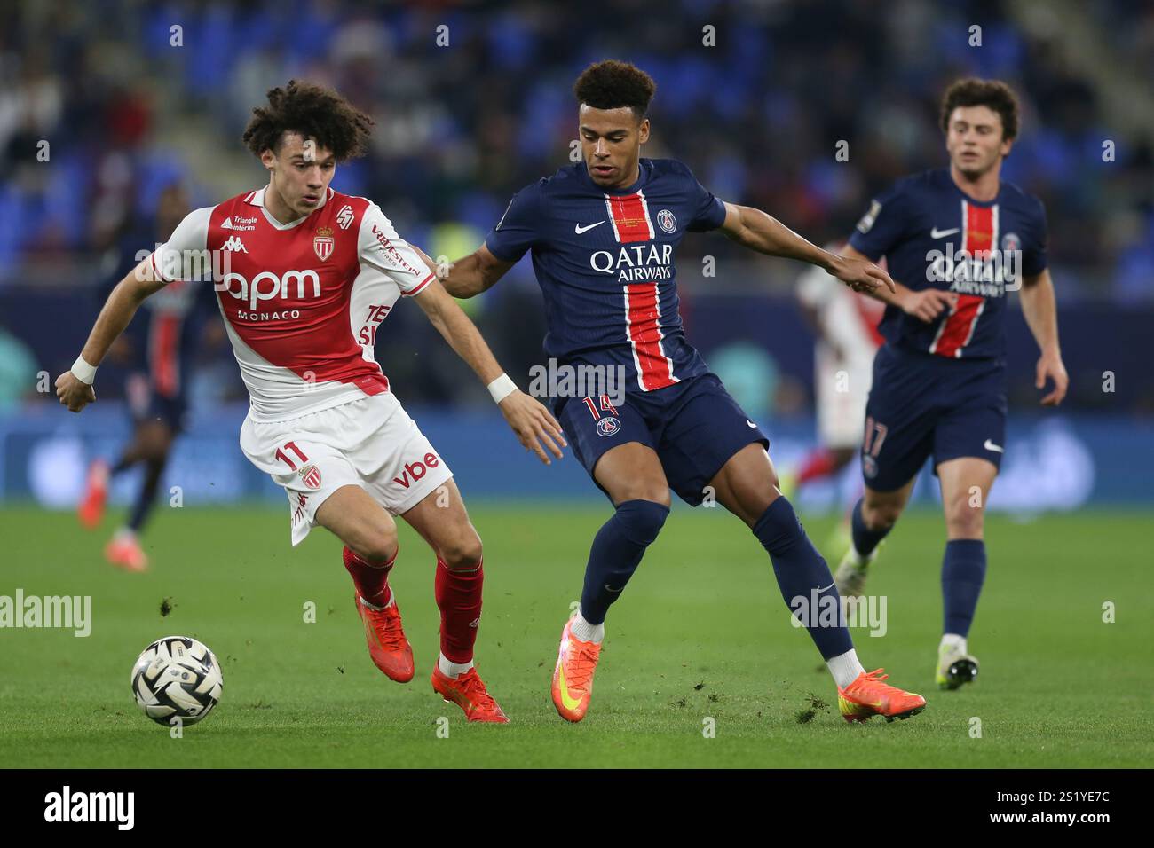 Monaco's Maghnes Akliouche in action by PSG's Desire Doue during the