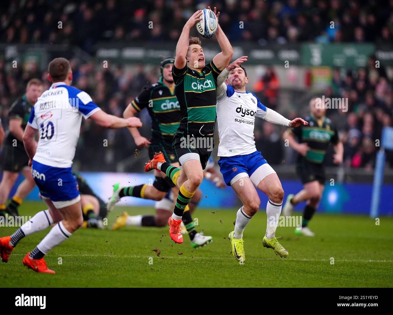 Northampton Saints' Fin Smith (centre) catches the ball above Bath's ...