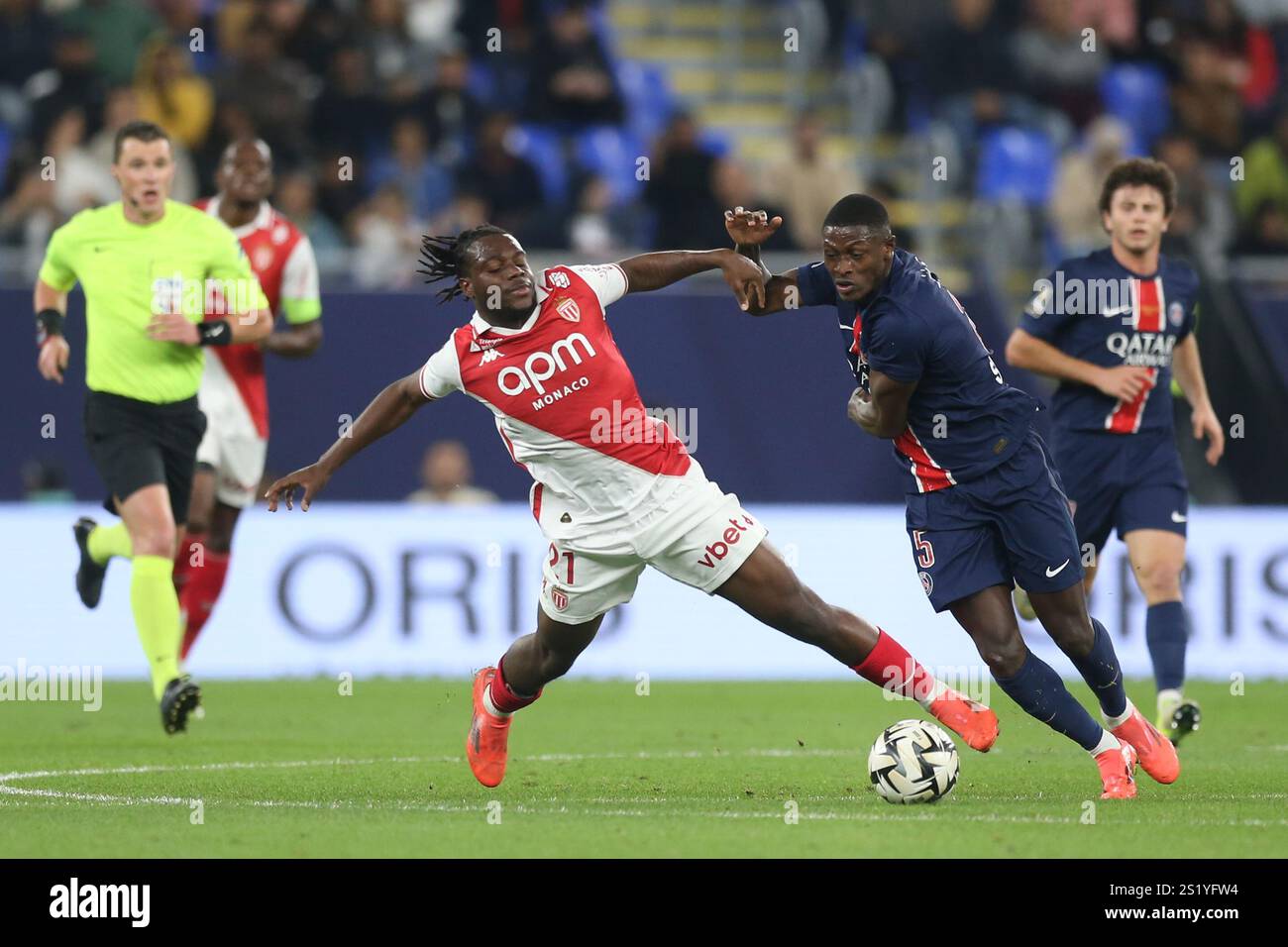 Monaco's Ilenikhena, left, and PSG's Nuno Mendes fight for the