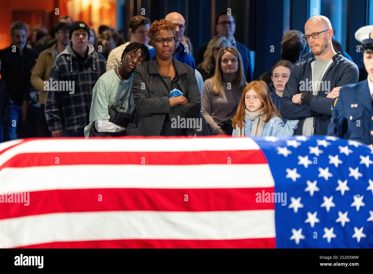 Mourners view the casket of former President Jimmy Carter as he lies in