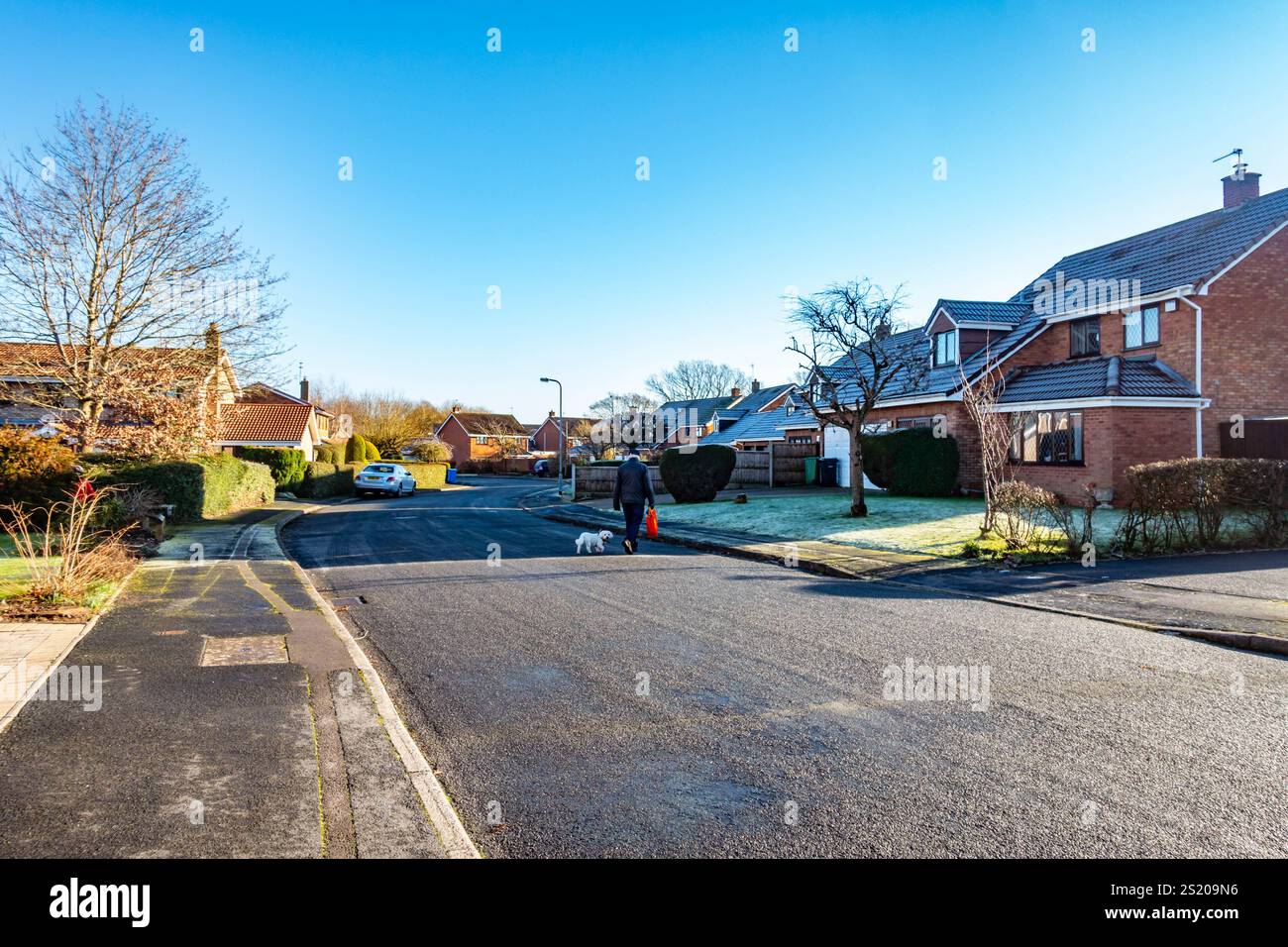 A view along a frosty street in the village of Perton in South Staffordshire near Wolverhampton in winter. Stock Photo