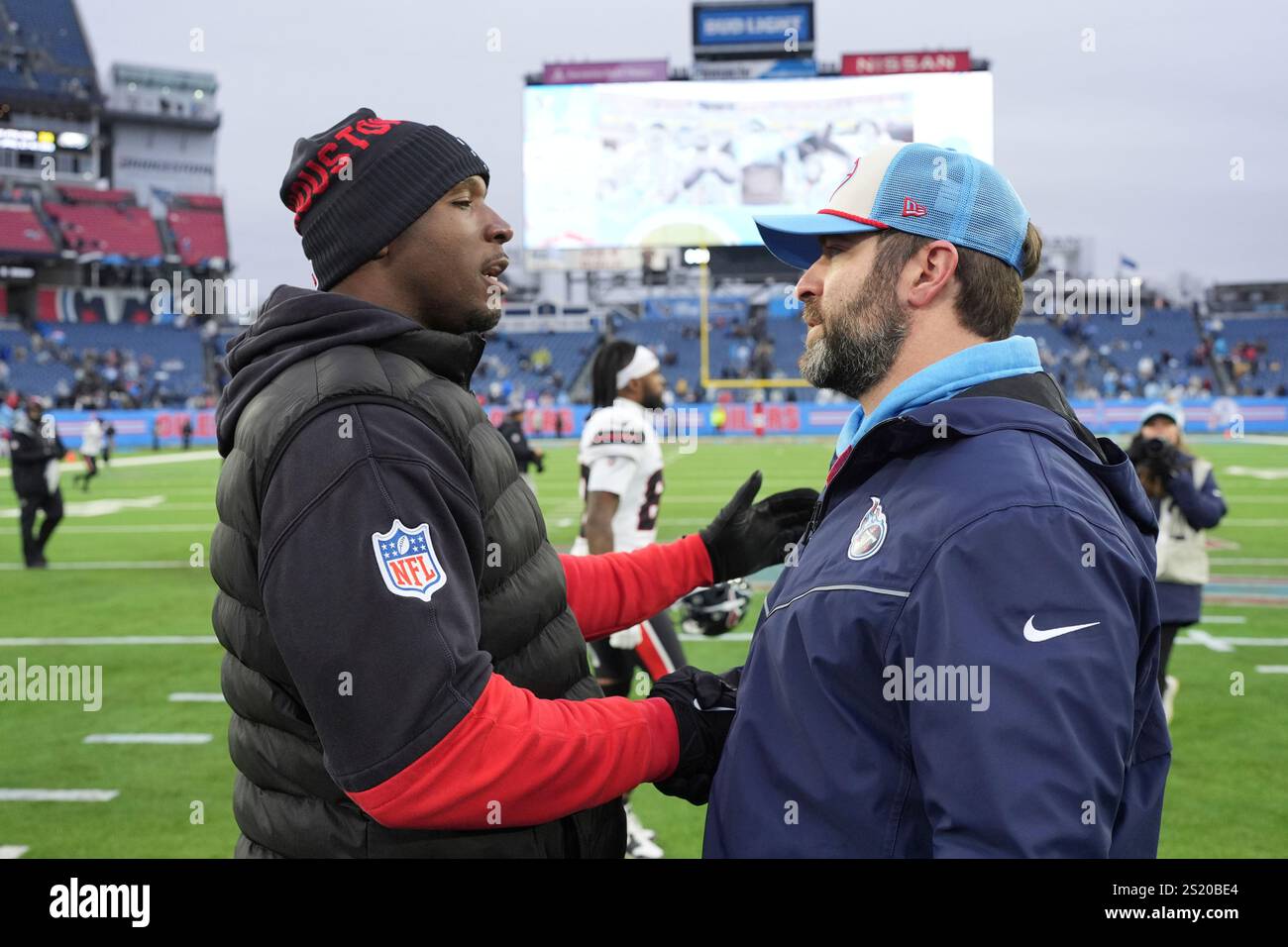 Houston Texans coach DeMeco Ryans, left, and Tennessee Titans coach