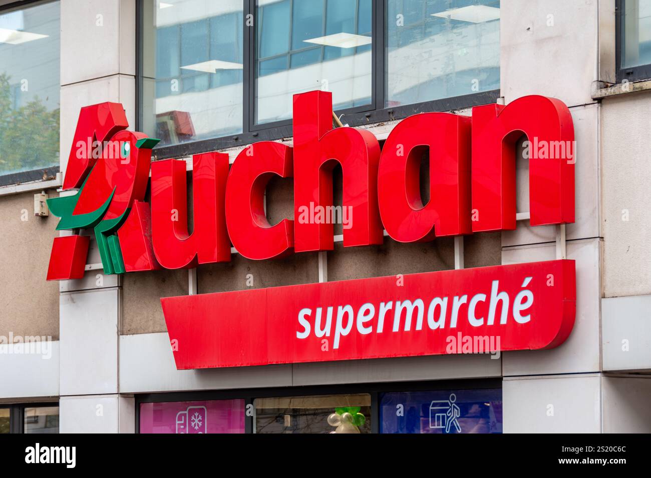 Sign and logo outside an Auchan supermarket. Auchan is a French ...