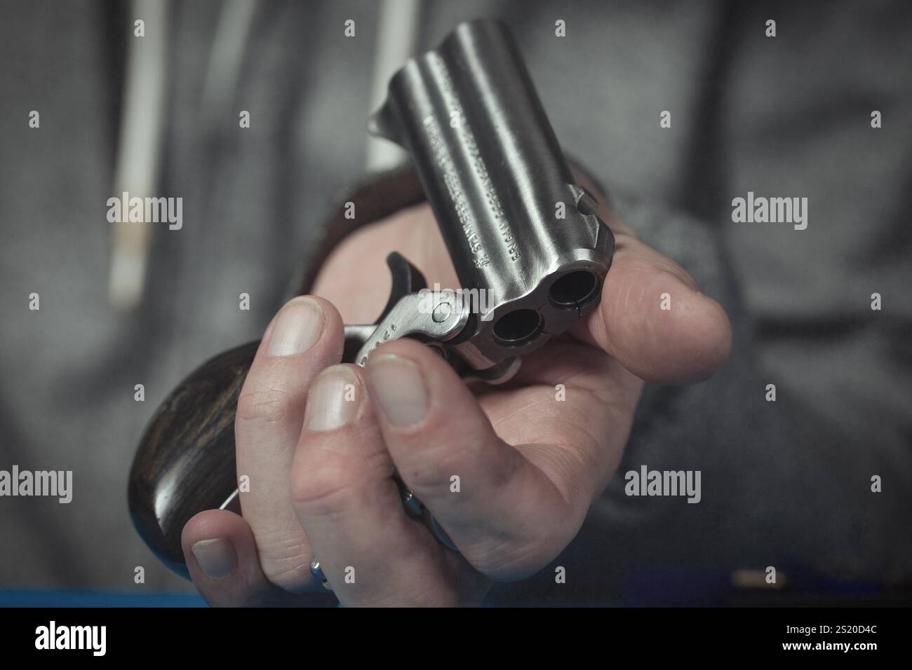 Man take care of two barrel derringer personal handgun caliber .38 ...