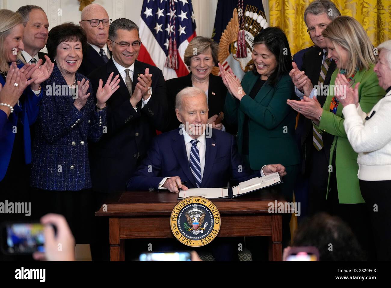 President Joe Biden signs the Social Security Fairness Act during a