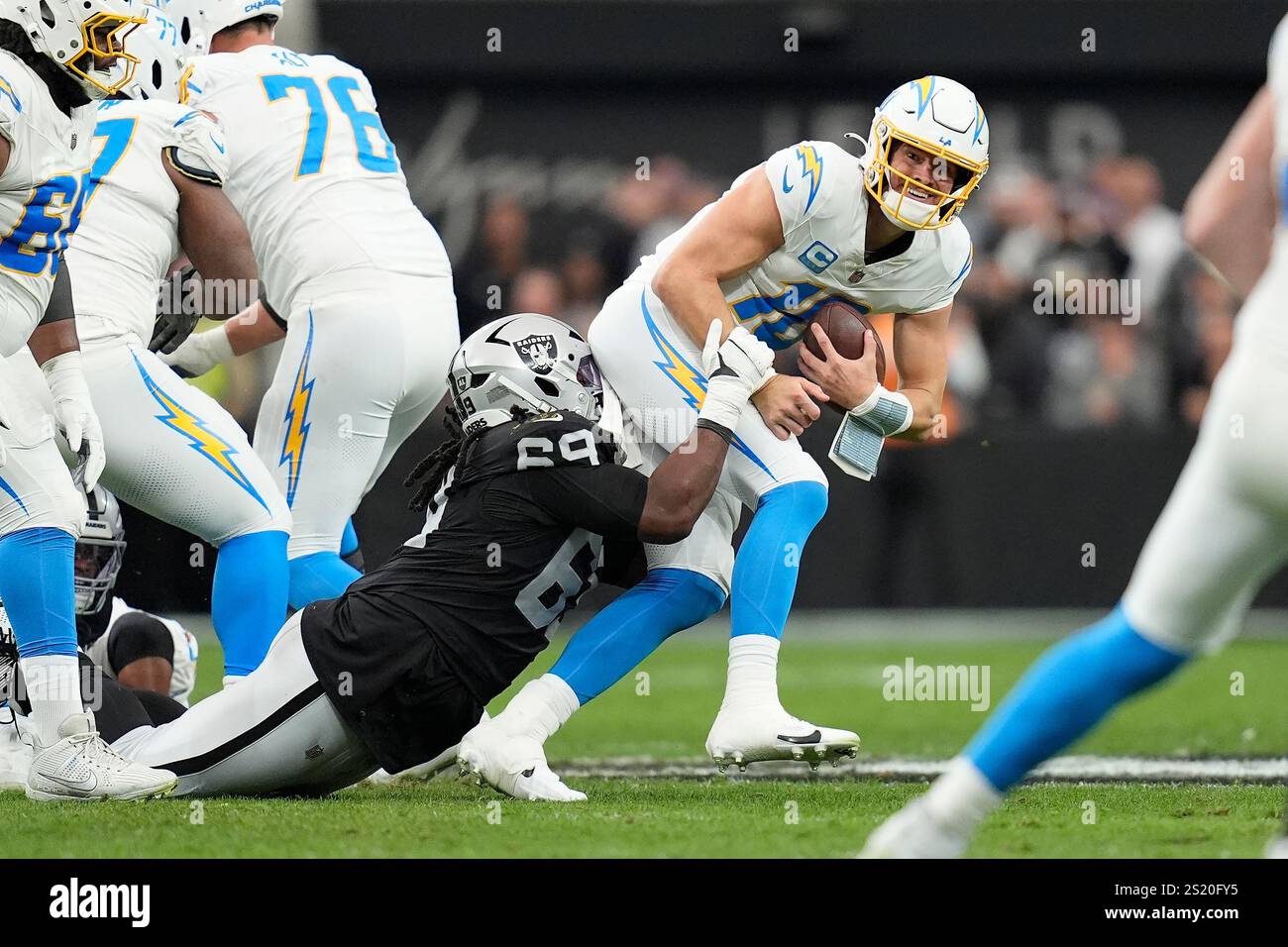 Las Vegas Raiders defensive tackle Adam Butler (69) sackes Los Angeles ...