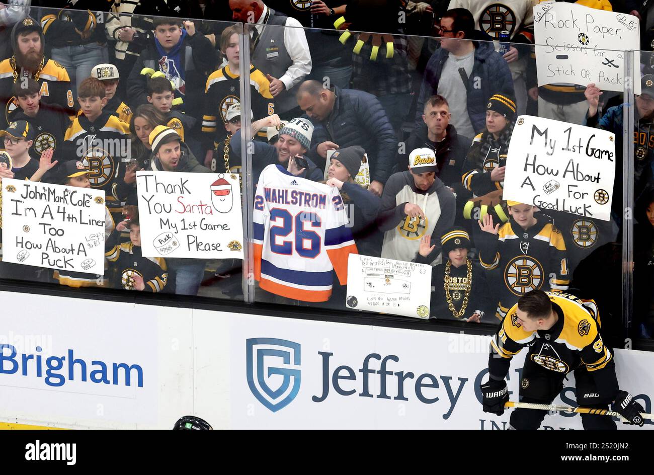 Boston Bruins fans try to get the attention of players as Boston Bruins