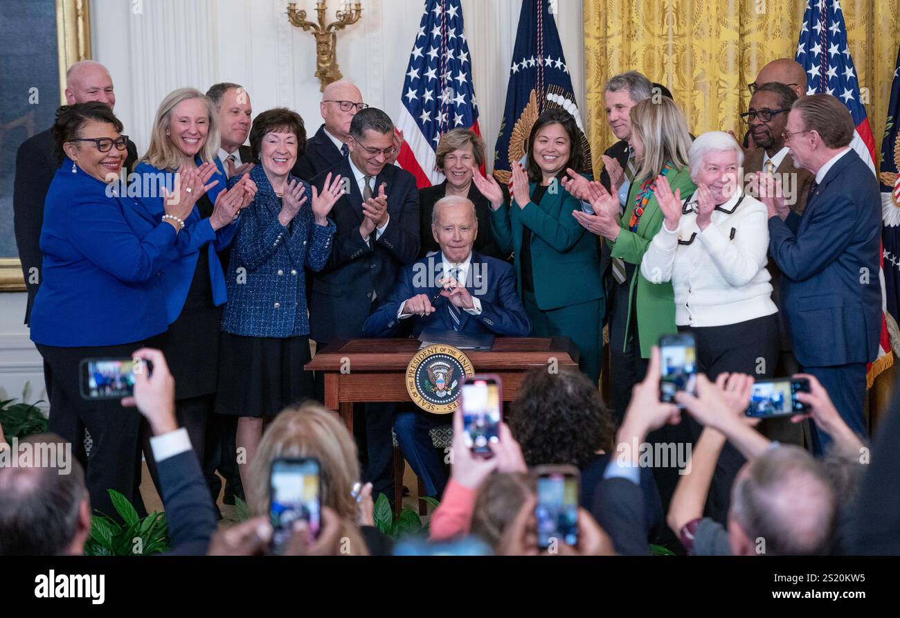 President Joe Biden signs the Social Security Fairness Act in the East Room of the White House