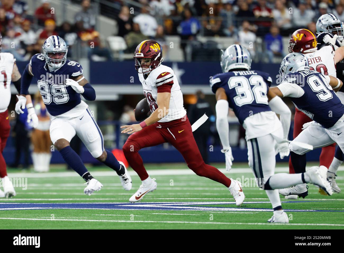 Washington Commanders quarterback Marcus Mariota (18) carries the ball during a NFL football