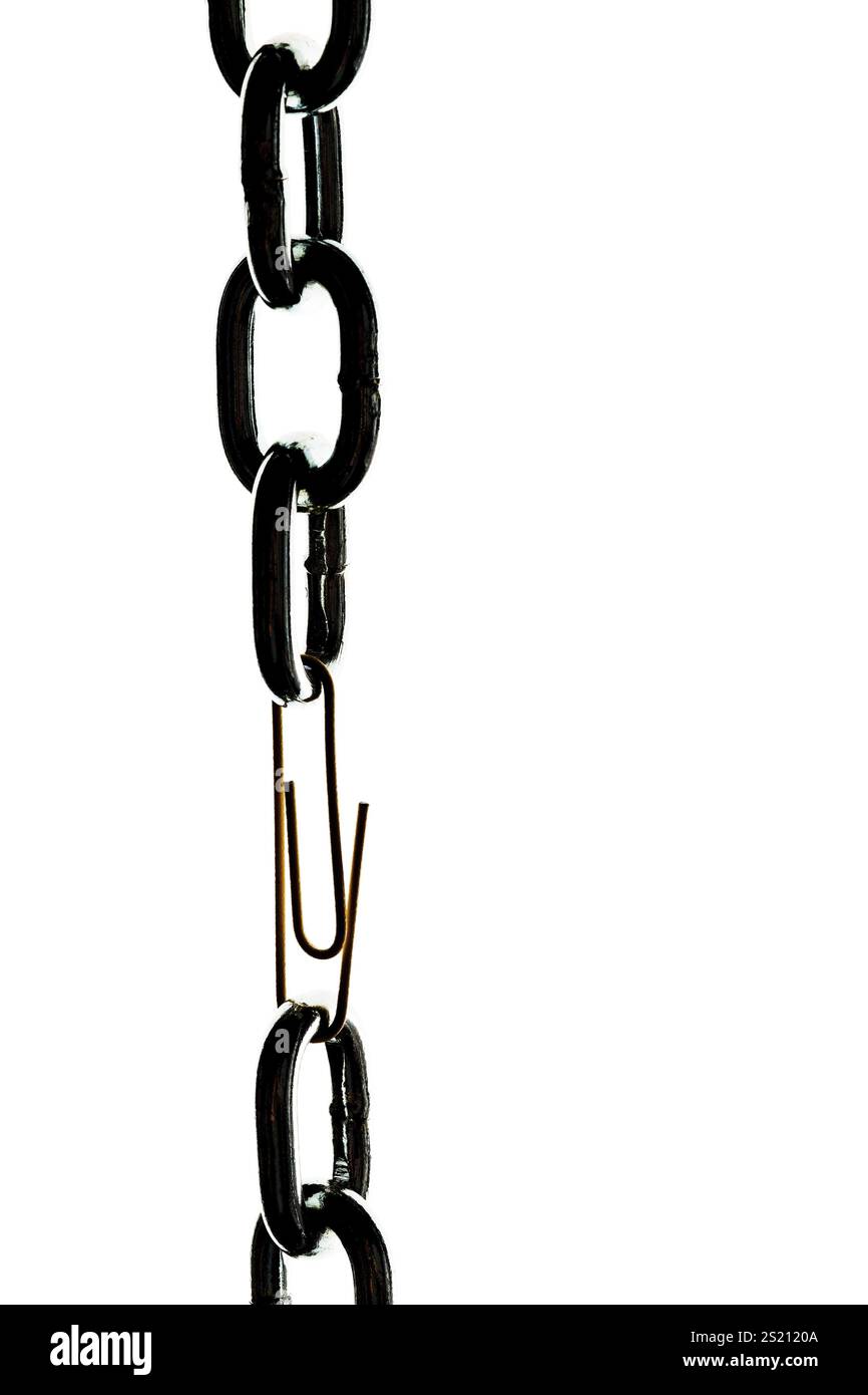 Defective steel chain is held together by a paper clip Austria Stock Photo