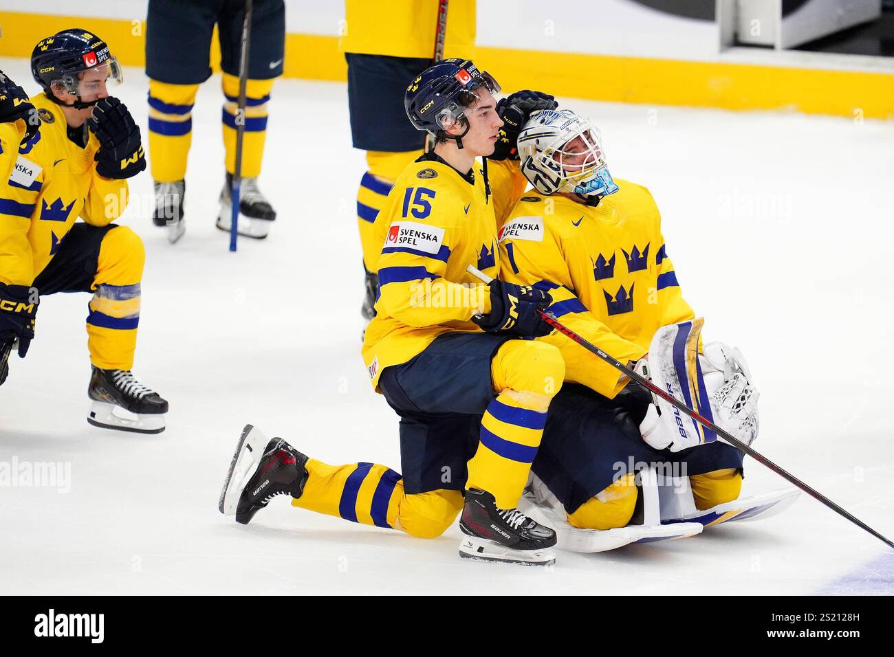 Sweden forward David Edstrom (15) consoles teammate Marcus Gidlof (1 ...