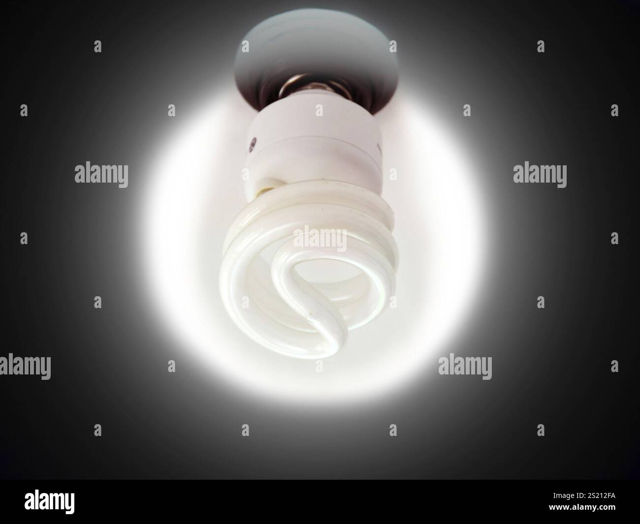 A shining white light bulb in a black circle Stock Photo