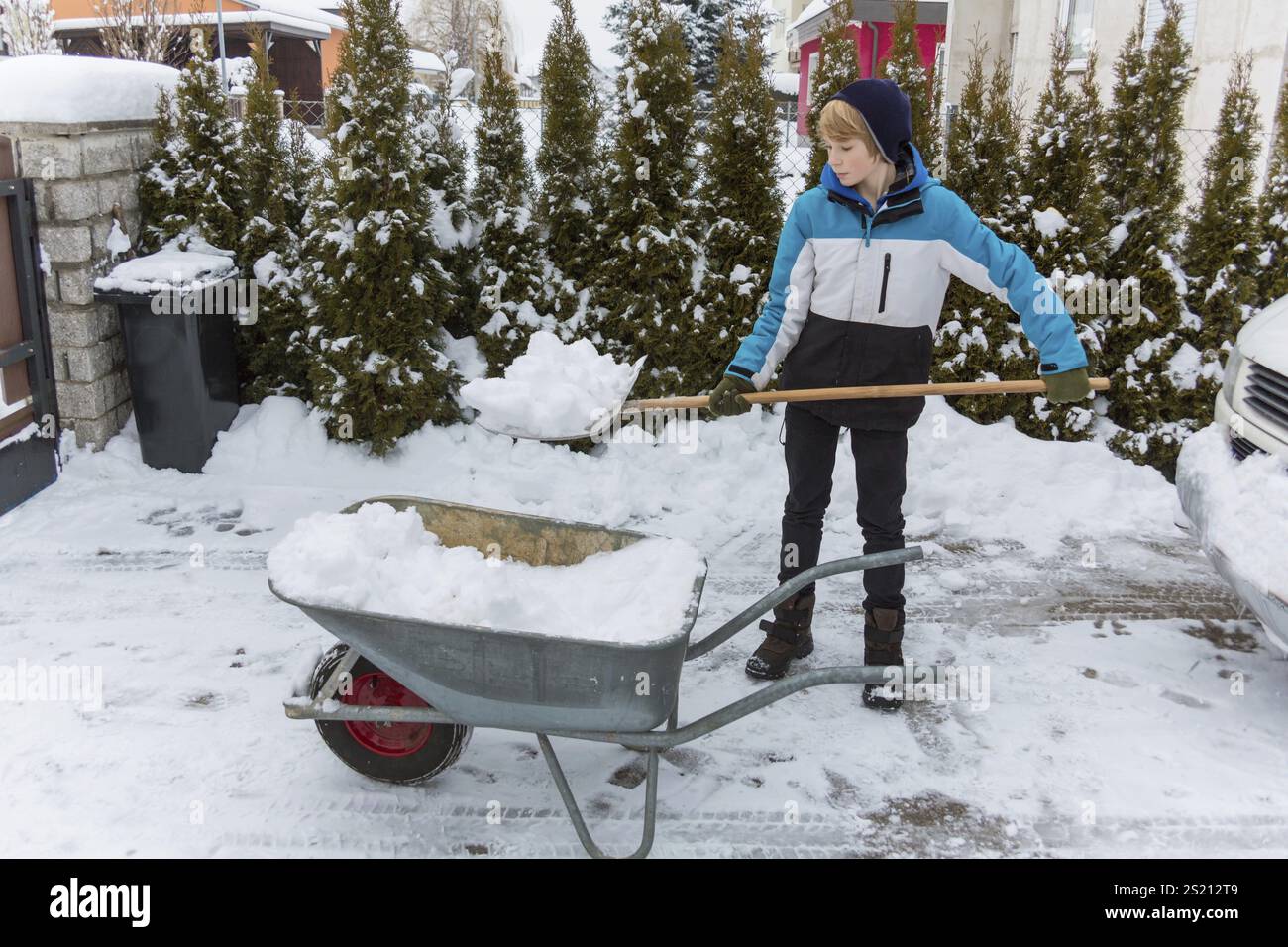 Snow is shovelled away from a house. Snow clearance in winter Austria Stock Photo
