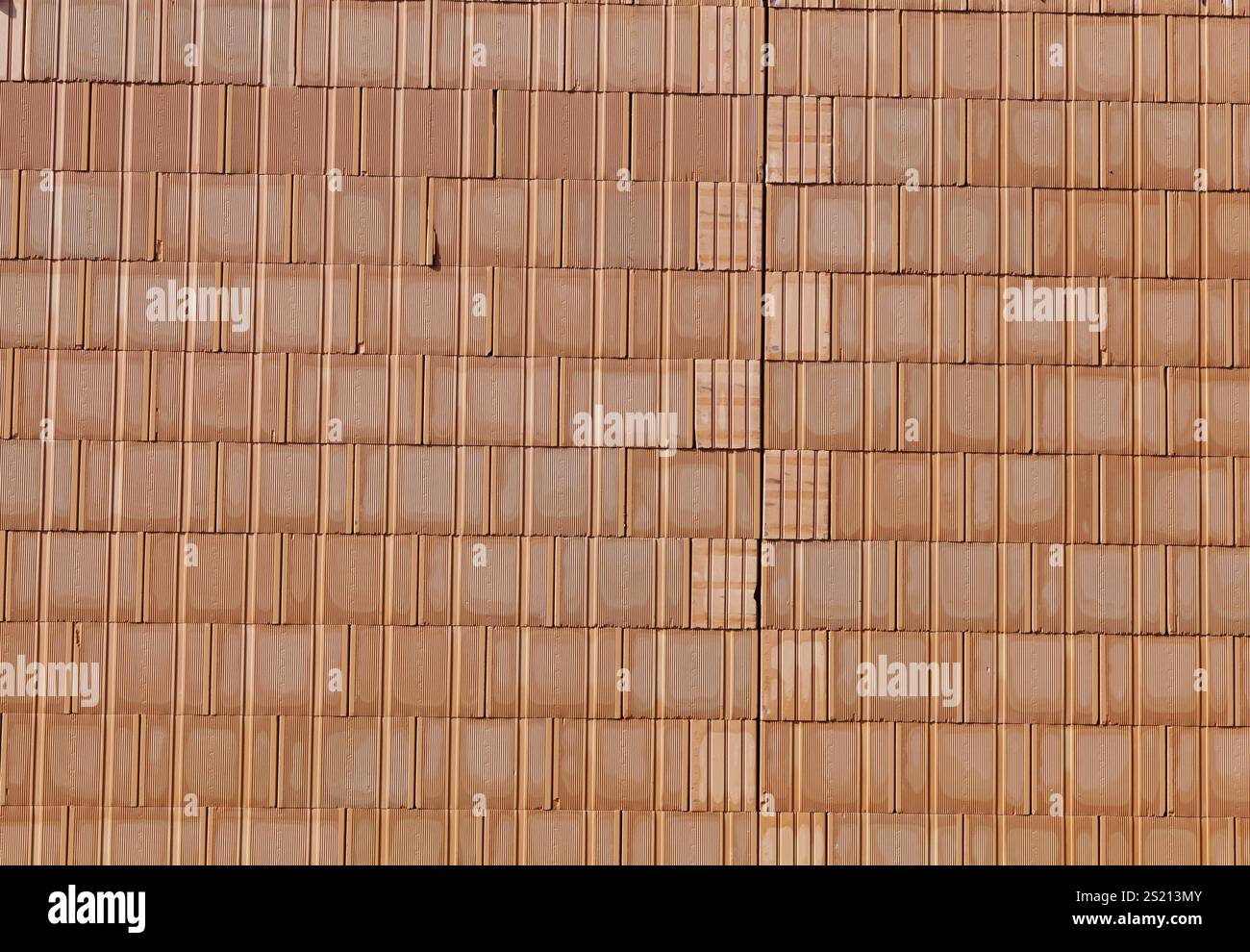 A new brick wall at a building shell house on a construction site ...