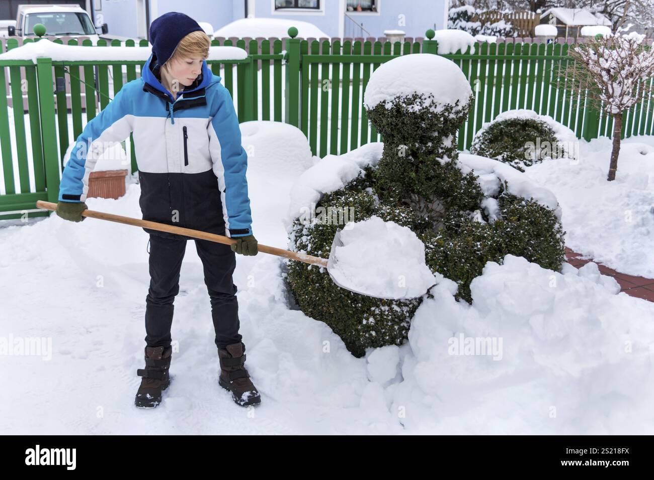 Snow is shovelled away from a house. Snow clearance in winter Stock Photo