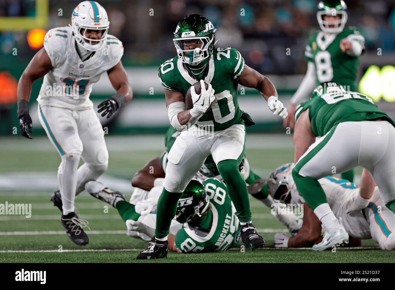 New York Jets running back Breece Hall (20) runs with the ball past