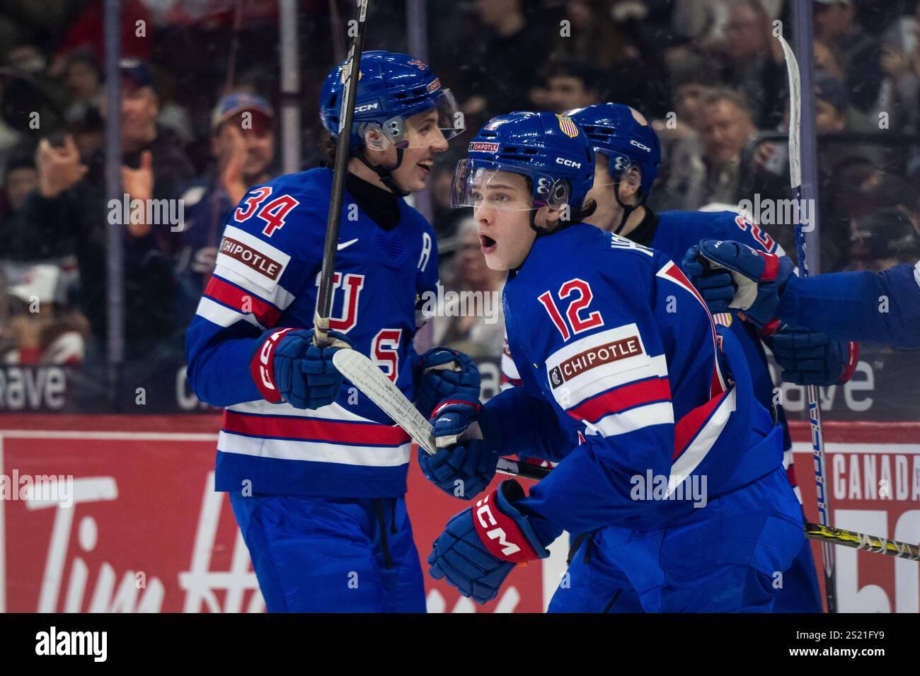 250105 James Hagens of USA celebrates with team mates after scoring 11