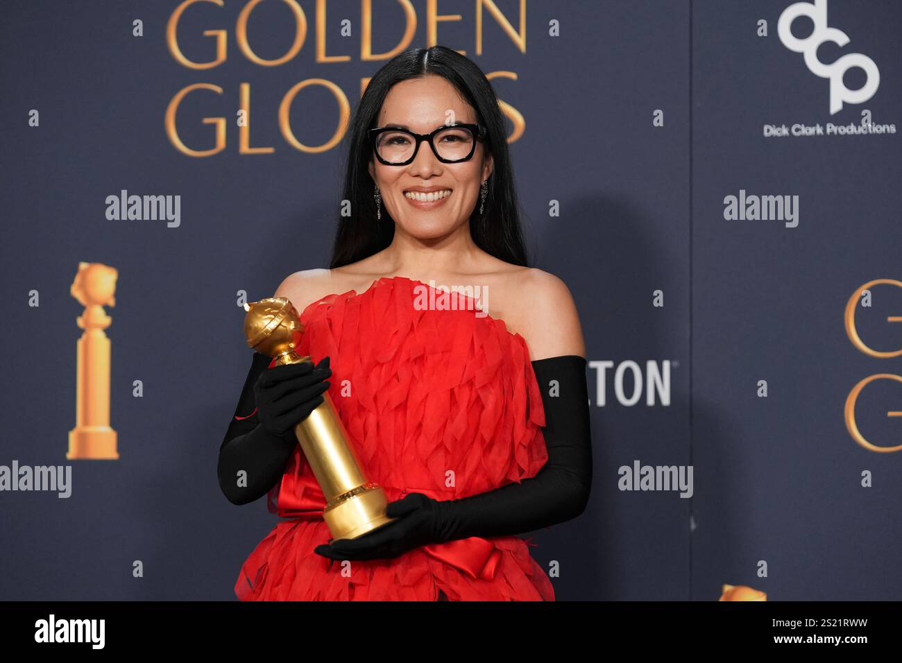 Ali Wong poses in the press room with the award for best performance in