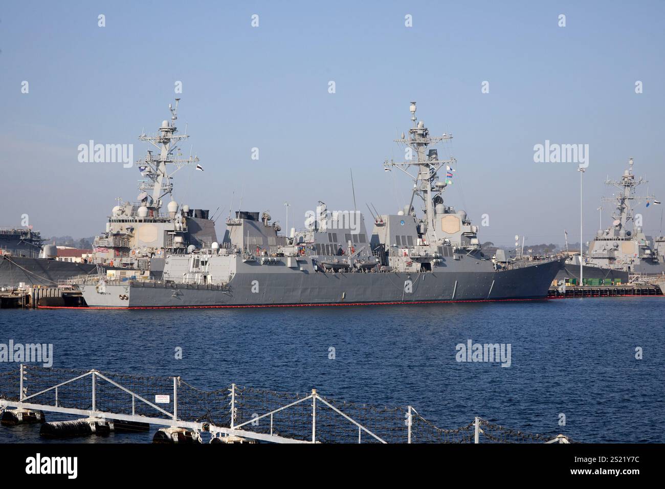 San Diego, California, USA. 21st Dec, 2024. The USS Mustin (DDG-89), an Arleigh Burke-class guided-missile destroyer, docked at the San Diego Naval Base. Known for its advanced Aegis Combat System and missile capabilities, the Mustin is a key asset in the U.S. Navy's fleet. The ship's sleek design, advanced radar systems, and weaponry are clearly visible, reflecting its role in modern naval operations. (Credit Image: © Ian L. Sitren/ZUMA Press Wire) EDITORIAL USAGE ONLY! Not for Commercial USAGE! Stock Photo