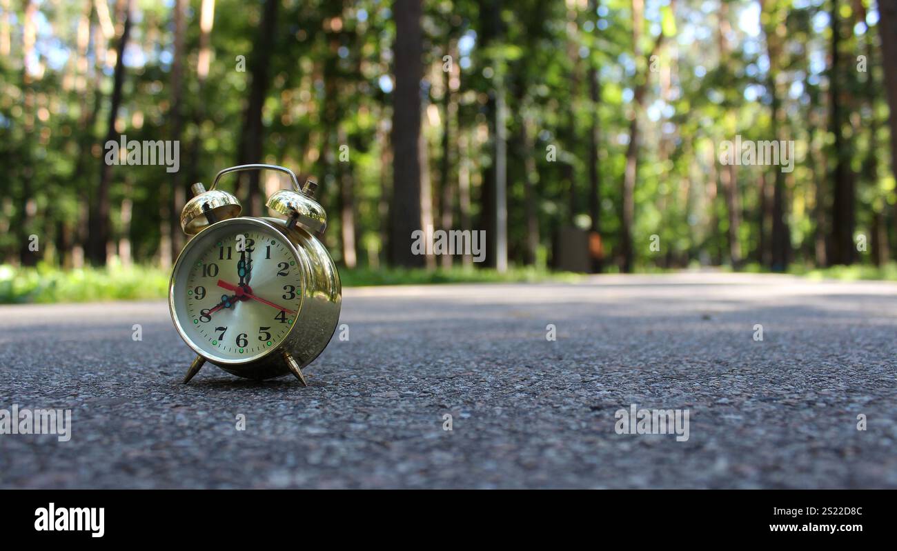 Vintage Bell Arrows Clock On A Blurred Walking Way With Benches In Park ...