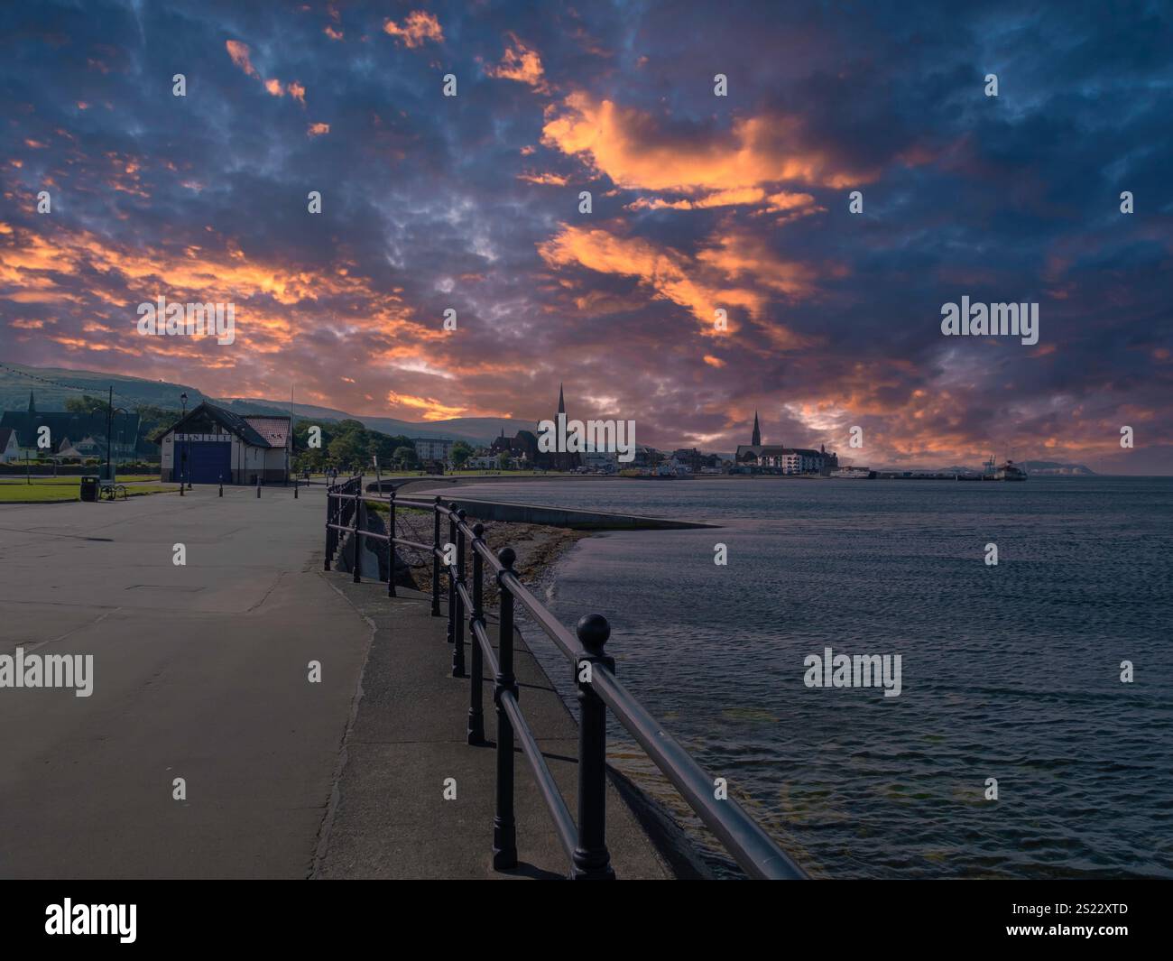 Looking along the north prom past the lifeboat station  and into Largs town centre in the eveniong at sunset. Stock Photo