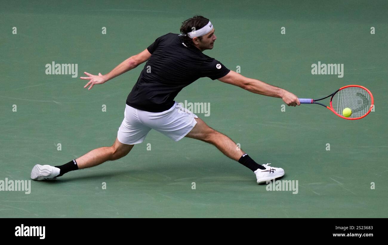 FILE - Taylor Fritz, of the United States, returns a shot to Jannik ...