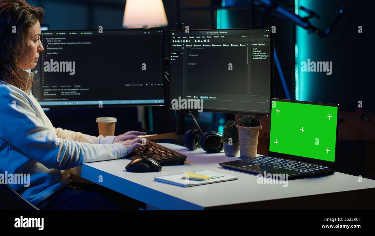 Programmer using green screen laptop to secure company servers from virus attacks. IT remote employee writing code, building firewalls protecting data using mockup notebook, camera A Stock Photo